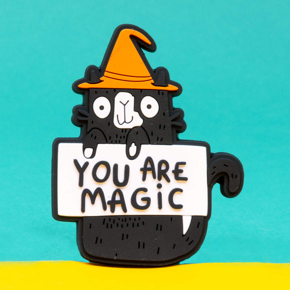 You are magic cat coaster is a black cat with an orange wizards hat illustrated by Katie Abey it is holding a sign saying You are Magic