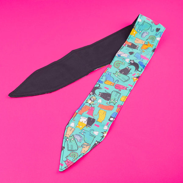 Handmade Reversible hair tie for vintage hairstyle, featuring illustrated cats on light blue fabric. Designed by Katie Abey X Dawny's Sewing Room in the UK