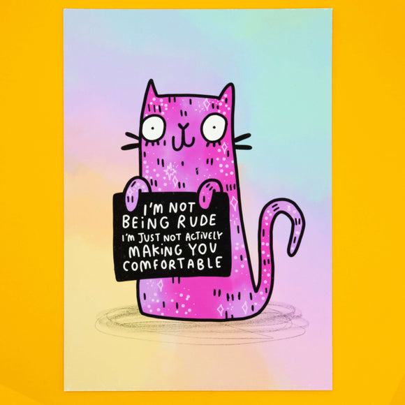 Front view of Katie Abey’s “I’m Not Being Rude” Cat Art Print against a yellow background. The bold pink illustrated cat holds a witty sign with a funny quote, making it the perfect wall art for cat lovers and people who embrace their weirdness. Limited edition A4 matte print, signed and numbered.