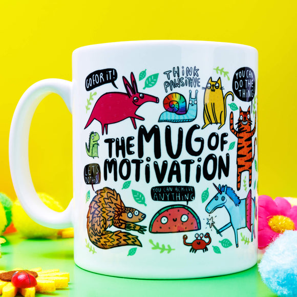 A white ceramic mug with lots of Katie Abey fun illustrations on telling you that you can do it. Text says the Mug of Motivation