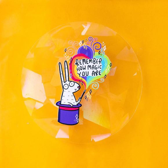 A see through sticker with a bunny in the middle coming out of a top hat Illustrated by Katie Abey text says remember how magic you are