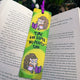 Time For Some No People Time Hedgehog Bookmark by Katie Abey placed inside an open book. Bright green and yellow striped background with illustrated hedgehog reading a purple book and holding a floral mug. Purple ribbon tie at the top. Funny introvert bookmark gift for book lovers and fans of quirky illustrated stationery.
