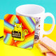 a coaster of a yellow cat on a rainbow striped background smiling holding a sign saying 'ABSOLUTE BOLLOCKS'