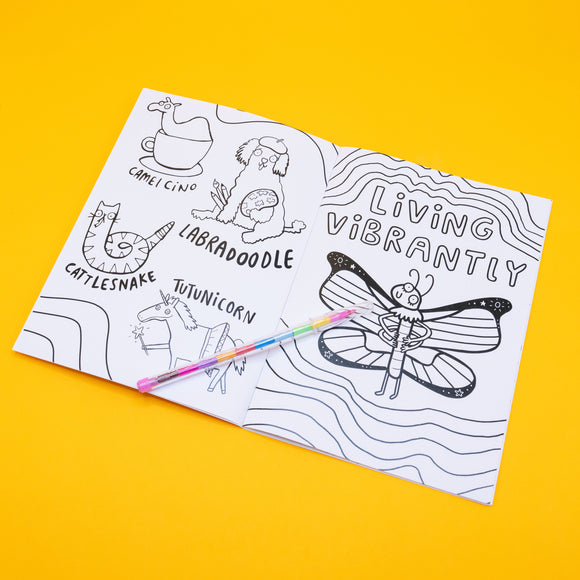 Open spread of the Stay Whimsical colouring book featuring fun hybrid creatures like “Camelcino,” “Labradoodle,” “Cattlesnake,” and “Tutunicorn.” The opposite page shows a butterfly with the words “Living Vibrantly.” A rainbow pen rests across the centre. Playful line art pages ideal for mindful colouring and creativity.