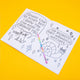 Open spread of the Stay Whimsical colouring book. One side shows the Chihuahua of Change saying, “Change can be scary but I know you can make it through this.” The opposite page has a cheerful snail with the phrase “No regrets, only whimsical mistakes.” A rainbow pen lies across the book. Full of uplifting affirmations and quirky characters.