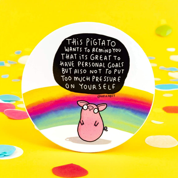 A white based sticker of a pig shaped like a potato with text saying this pigtail wants to remind you that its great to have personal goals but also not to put too much pressure on yourself.