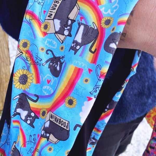 sky blue scarf with cats, rainbows and flowers illustrations all over by Katie Abey