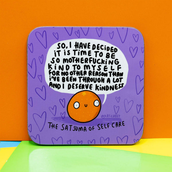 Satsuma of Self Care Coaster is a purple coaster with heart background and an illustrated satsuma smiling with a speech bubble saying 'So, Have decided it is time to be so motherfucking kind to myself for no other reason than I've been through a lot and I deserve Kindness.'