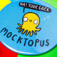 Mocktopus the Octopus pocket mirror, featuring illustrated yellow smiley octopus with speech bubble reading 'Ha! Your Face'. Designed in the UK by Katie Abey