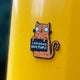 Swear Word Orange and Black Cat Fridge Magnet holding funny sign. Designed by Katie Abey in the UK