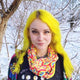 Katie wearing the Rainbow Jersey Circle Scarf. The yellow scary has rainbow illustrations all over by Katie Abey