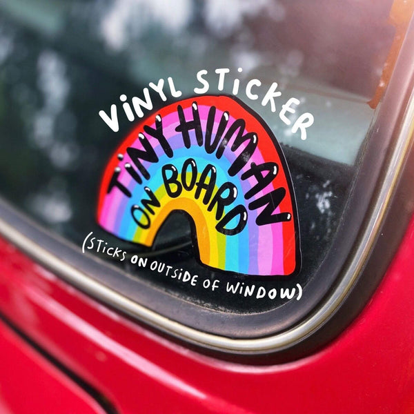 Tiny human on board vinyl car window sticker featuring black text on a rainbow design by Katie Abey laminated and weather proof