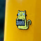 Swear Word Yellow and Black Cat Fridge Magnet holding funny sign. Designed by Katie Abey in the UK