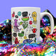 Katie Abey's white mug adorned with a variety of whimsical, illustrated monsters and uplifting quotes, like "You lookin' fly" and "Small steps every day," resting on a shimmering, colourful sequin backdrop.