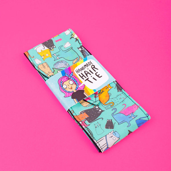 Handmade Reversible hair tie for vintage hairstyle, featuring illustrated cats on light blue fabric. Designed by Katie Abey X Dawny's Sewing Room in the UK