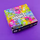 An image of a box with The Puzzle of positivity written in the middle with lots of fun illustrated characters on it by Katie Abey on a purple background