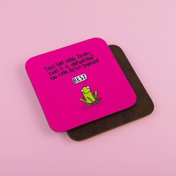 the tiny frog of rest is a cute illustration by Katie Abey on a pink base coaster with text saying This tiny frog thinks that it is important you look after yourself with a speech bubble saying REST