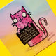 Close-up angled photo of the Katie Abey “I’m Not Being Rude” cat coaster, showing the pink doodle-style cat holding its sarcastic sign. The pastel rainbow background and bold illustration stand out clearly against a bright yellow backdrop. A cute, sassy homeware accessory for cat lovers and fans of quirky British illustrators.