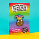 Katie Abey soft enamel pin featuring the 'Pinecone of Priorities' wearing a colourful jester hat and crown. The pin is displayed on a bright backing card with a rainbow background and the motivational phrase 'The entire point of us being here is to be daft and kind and have fun'. The artist's name, Katie Abey, is also featured at the bottom.