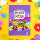 Purple postcard with rainbow going horizontally across the front with an illustration of a tiger with a blue scarf and red boots on with speech bubble above it's head that reads 'I don't care what you think of me. Unless you think I'm awesome, in which case you are correct.'. There is an arrow pointing at the tiger saying 'the tiger of unapologetic awesomeness' in white writing and white stars around it.