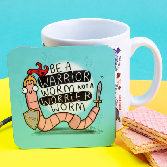 Be a warrior worm not a worrier worm coaster with a worm wearing a helmet and sword on a blue background. It is standing up against a yellow backdrop