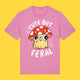 Bubble pink unisex t shirt featuring the Cute But Feral Cat artwork by Katie Abey. Illustrated cat in a red spotted mushroom hat with Cute But Feral text. Fun, colourful graphic tee for adults.