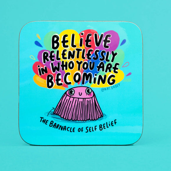 blue coaster with an illustration of a barnacle by Katie Abey with Believe relentlessly in who you are becoming written on the top and The Barnacle of self Belief written underneath.