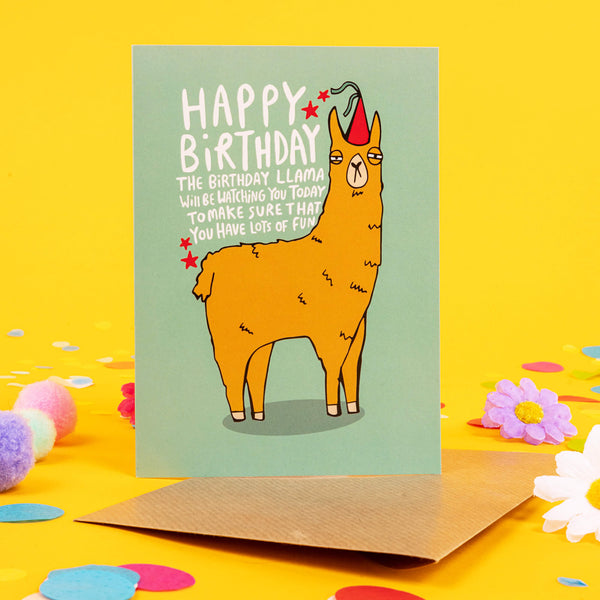 Funny Happy birthday llama A6 greetings card featuring grumpy llama wearing party hat on teal green background. Designed by Katie Abey