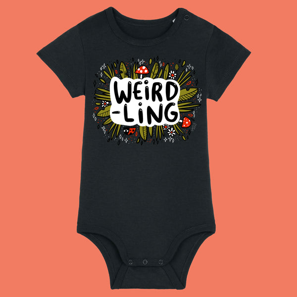Black organic cotton baby bodysuit featuring the “Weird-Ling” illustration by Katie Abey. Whimsical design with mushrooms, leaves and playful typography celebrating weirdness. Short sleeve baby grow with shoulder snap placket and popper fastening for easy dressing, perfect for quirky baby gifts.