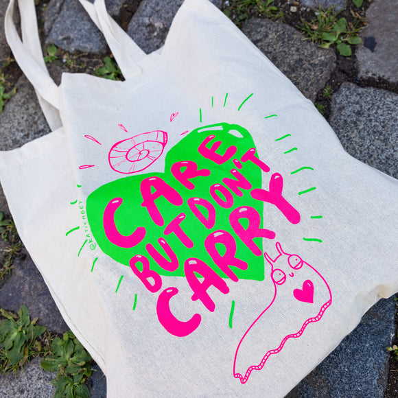 Snail Boi Tote bag. A white tote bag with pink text reading 'care but don't carry' on top of a green heart with pink snail illustrations.