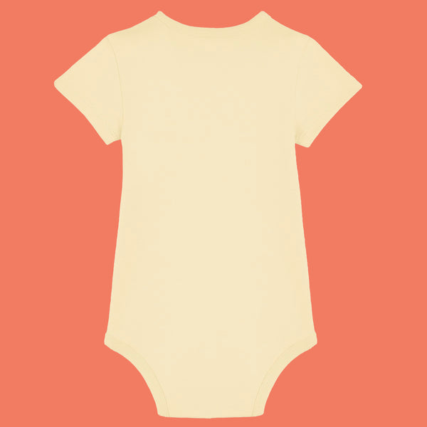 Butter yellow organic cotton baby bodysuit by Katie Abey shown from the back. Soft short sleeve babygrow made from breathable interlock cotton with popper fastening for easy changes. Cute alternative baby clothing designed by a UK illustrator who celebrates weird and wonderful personalities.
