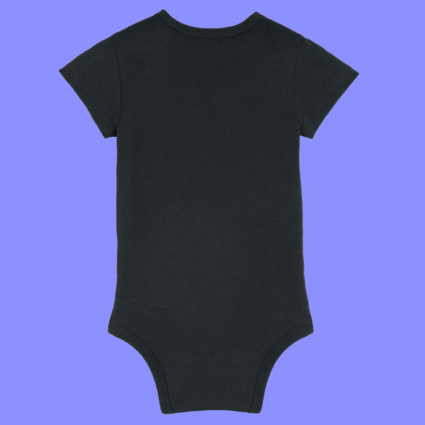 Black baby short sleeve babygrow shown from the back. Plain organic cotton baby bodysuit with a soft comfortable fit, ribbed neckline and leg openings, and popper fastenings for quick changes.