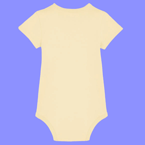 Butter yellow baby short sleeve babygrow shown from the back. Plain design with soft organic cotton fabric, short sleeves and snap fastenings at the bottom. Unisex baby clothing suitable for everyday wear, designed for comfort and easy changing.