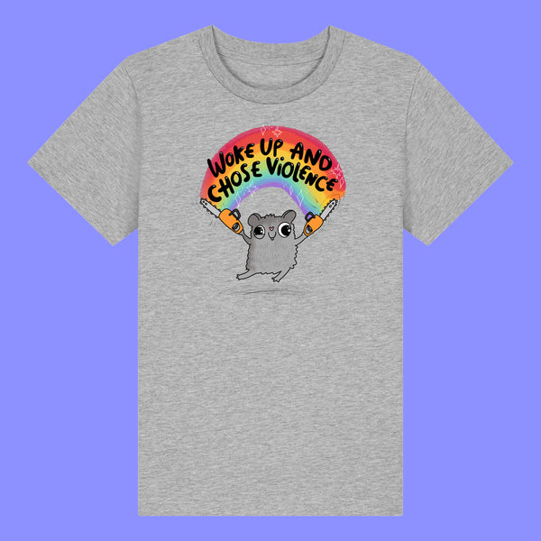Kids heather grey t shirt laid flat showing the front of the Woke Up And Chose Violence Hamster Kids Tee by Katie Abey. Features a bold illustrated hamster holding chainsaws under a rainbow with playful text, printed on soft organic cotton.