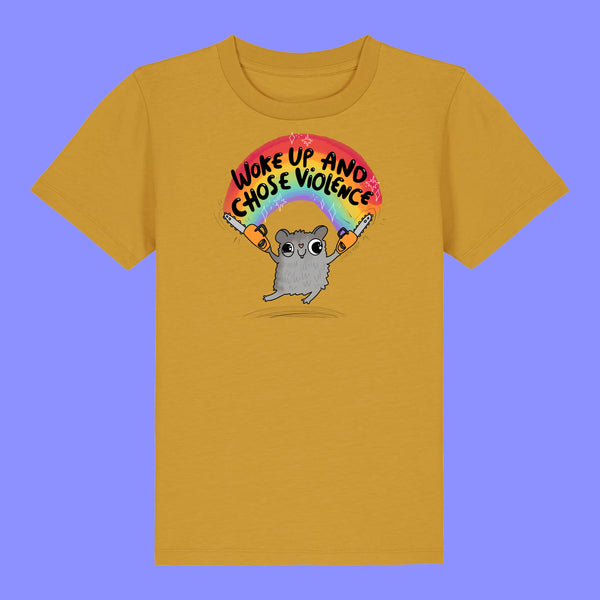 Kids ochre t shirt laid flat showing the front of the Woke Up And Chose Violence Hamster Kids Tee by Katie Abey. Features a cheeky illustrated grey hamster holding chainsaws under a rainbow with bold text, printed on an organic cotton children’s tee.