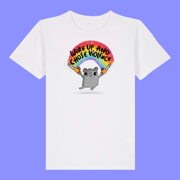 Kids white t shirt laid flat showing the front of the Woke Up And Chose Violence Hamster Kids Tee by Katie Abey. Shows a playful hamster illustration holding chainsaws under a rainbow with bold lettering on a white organic cotton tee.