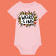 Cotton pink organic cotton baby bodysuit featuring the “Weird-Ling” design by Katie Abey. Playful illustration with mushrooms, foliage and bold lettering celebrating being weird and wonderful. Short sleeve baby grow with shoulder snap fastening and bottom poppers, ideal for quirky baby gifts and alternative baby clothes.