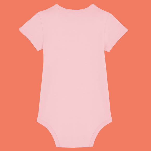 Cotton pink organic cotton baby bodysuit by Katie Abey shown from the back. Soft short sleeve babygrow with comfy interlock fabric and popper fastening for easy nappy changes. Cute unisex baby clothing designed by a small UK illustrator encouraging little ones to embrace their weirdness.
