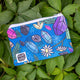  Crystal Critters coin purse in blue with illustrated spiders, daisies, pin needs and crystals