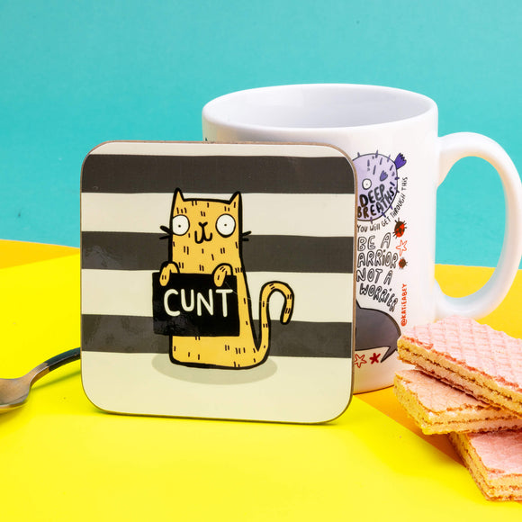 A very naughty swearing yellow cat holding a sign that says 'cunt' on a black and what striped background.