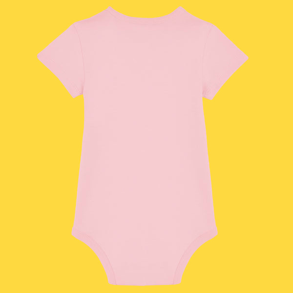 Soft pink organic cotton baby grow shown from the back, featuring short sleeves, ribbed neckline and leg openings, and a popper fastening at the bottom. A plain pastel pink design made from breathable organic cotton, ideal for everyday comfort for babies.
