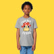 Front view of a child wearing the Cute But Feral Cat Kids T Shirt by Katie Abey in heather grey. Features Katie Abey’s Cute But Feral cat artwork with mushroom illustration and bold white lettering on a soft organic cotton kids T shirt.