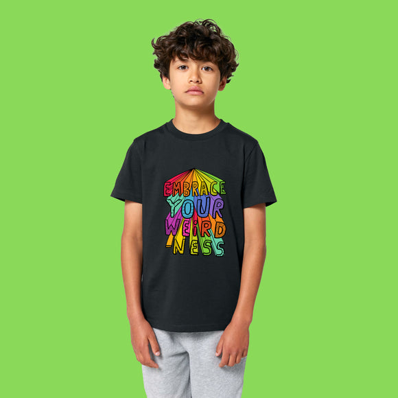 Child wearing Embrace Your Weirdness kids t shirt by Katie Abey in black. Bright rainbow artwork stands out against black fabric celebrating individuality and creativity. Soft organic cotton tee made for confident weird kids.