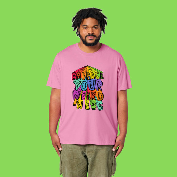 Front view of a second model wearing the pink Embrace Your Weirdness adults t shirt. The rainbow inspired illustration and bold lettering are clearly visible on the chest, showing how the tee fits across different body types.