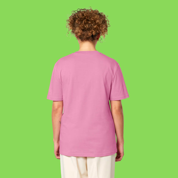 Back view of a model wearing the pink Embrace Your Weirdness adults t shirt. The bubblegum pink tee has a relaxed unisex fit and plain back. Styled casually to show the drape and length of the t shirt.