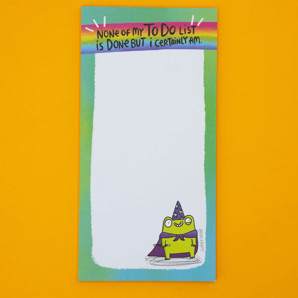 Detail of Katie Abey frog pad showing green wizard frog illustration with purple cape and starry hat. Humorous notepad design, ideal gift for stationery lovers, list makers, or anyone who enjoys playful motivational office supplies.