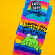 Close up of rainbow striped Katie Abey socks with a cute green frog and the phrase I Have No Idea What The Happ F*ckening. The socks are set against a vibrant yellow background. Colourful novelty frog socks by illustrator Katie Abey designed to spread joy and celebrate weirdness.
