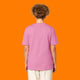Back view of a model wearing the Katie Abey Grateful To Be Here But Respectfully WTF adults t shirt in bubble pink. Unisex organic cotton tee with short sleeves and a relaxed fit, featuring a plain back and styled against a bright orange studio background.
