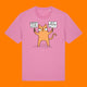 Front view of the Katie Abey Grateful To Be Here But Respectfully WTF bubble pink graphic t shirt. Features a quirky orange cartoon cat holding signs reading “Grateful To Be Here” and “But Respectfully… WTF”, illustrated by Katie Abey.