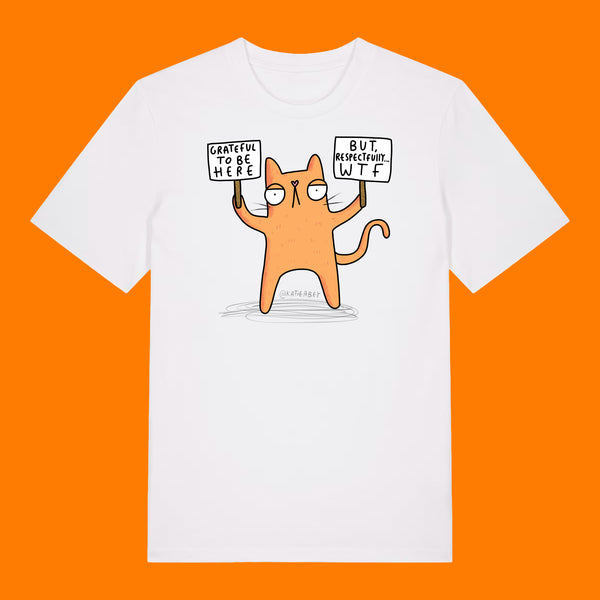 Front view of the Katie Abey Grateful To Be Here But Respectfully WTF adults graphic t shirt in white. Features a humorous cartoon cat holding signs reading “Grateful To Be Here” and “But Respectfully… WTF”, illustrated by Katie Abey. Funny alternative graphic tee on an orange background.